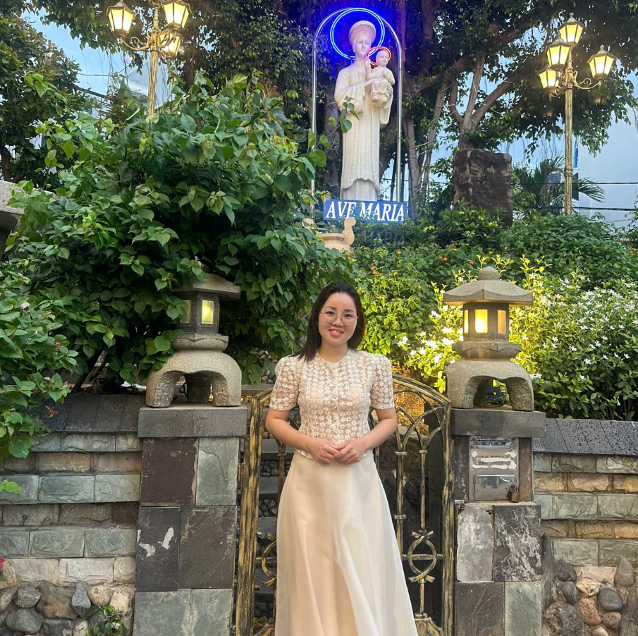 Portrait of a woman wearing a green-trimmed white polo